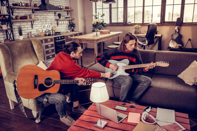 Laptop running FileMaker and Teachers Companion with a guitar student and teacher