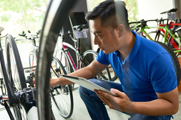 Bike bicycle shop business owner using digital tablet